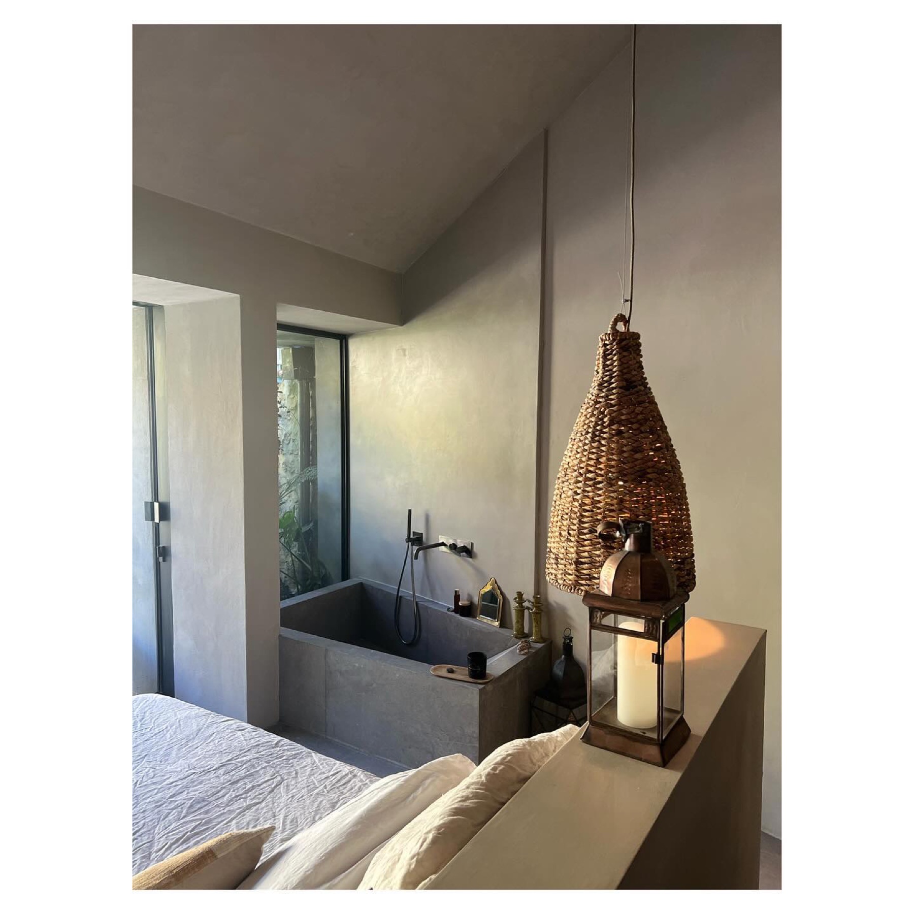 Chambre avec baignoire en béton et suspension en rotin — Casa Jungle