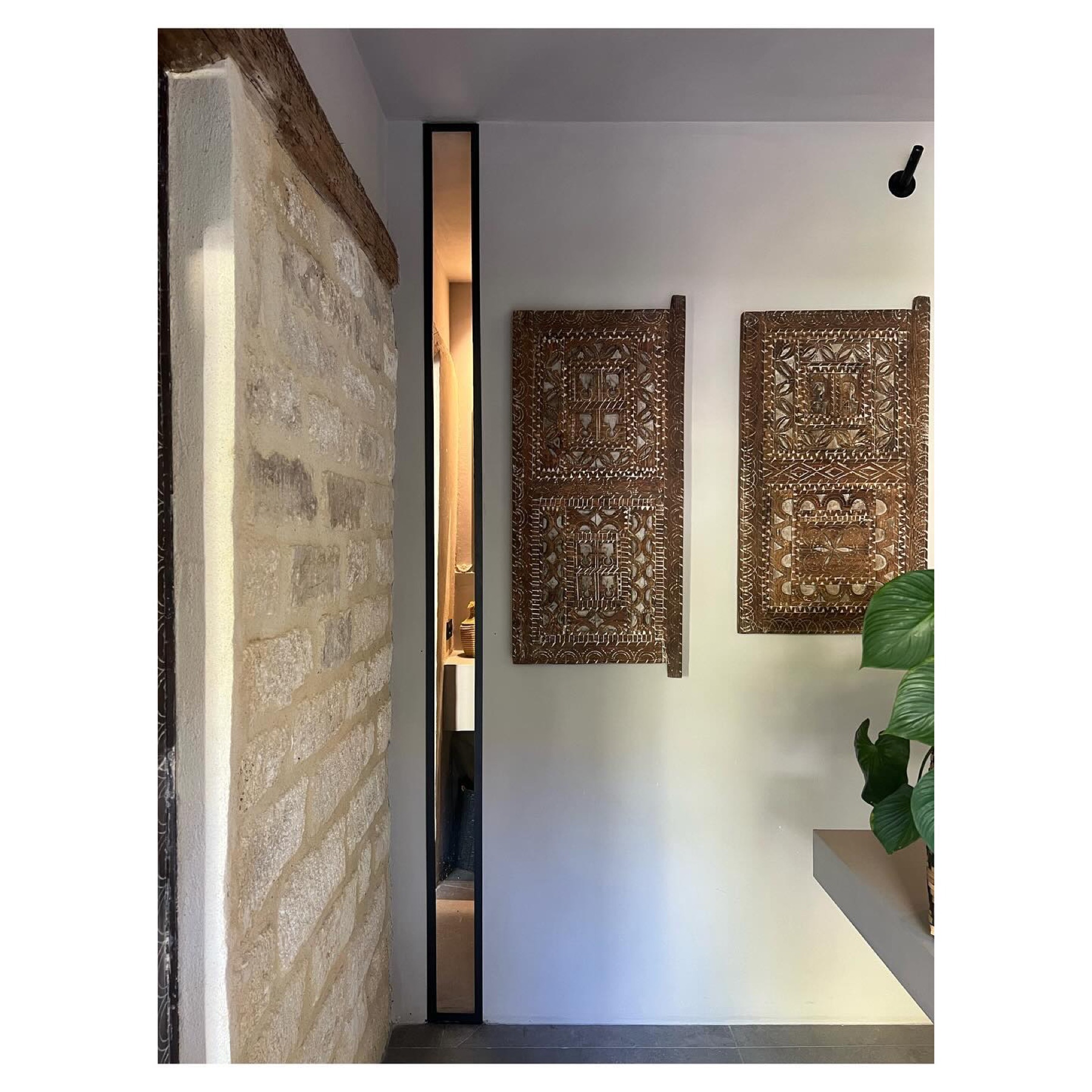 Entrée, mur de pierre et panneaux de bois sculptés — Casa Jungle